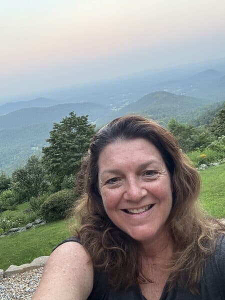 Kathy Clark, founder of Moxie Mobility Training, smiling at a mountain overlook