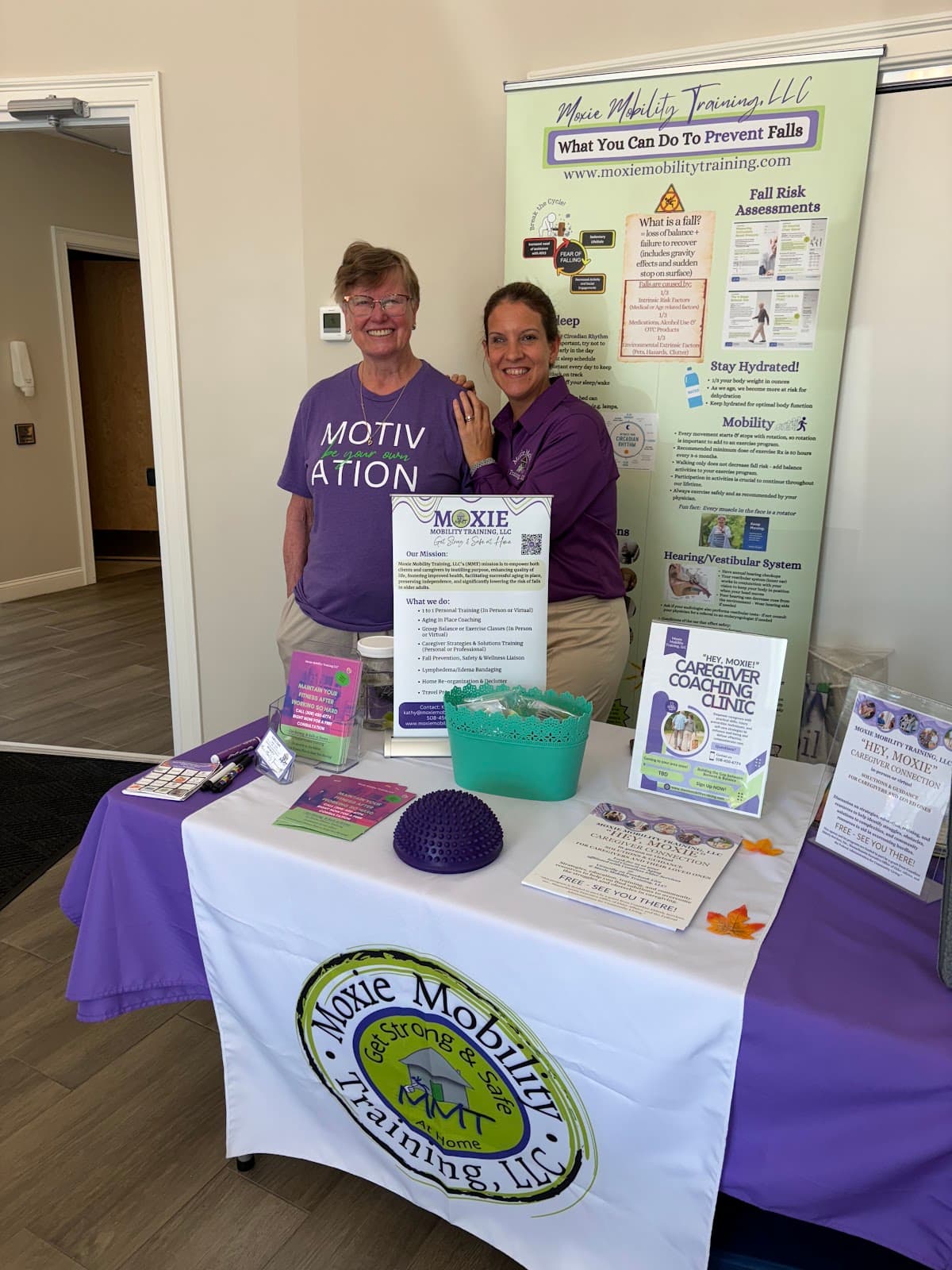 Kathy Clark at a Moxie Mobility Training community health fair booth connecting with the local senior community