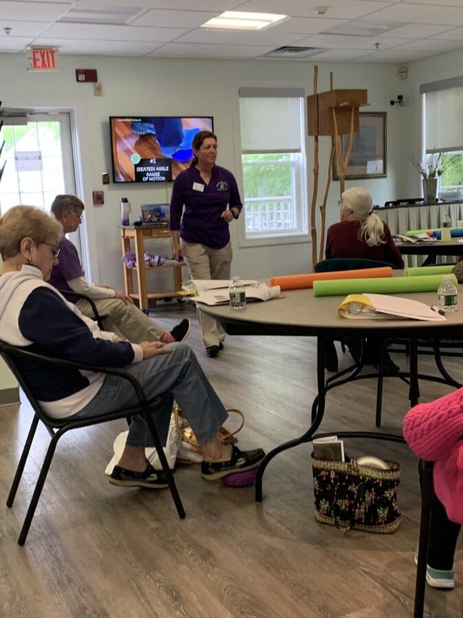 Kathy Clark leading a seated ankle mobility exercise class for seniors at a community center in Southcoast Massachusetts