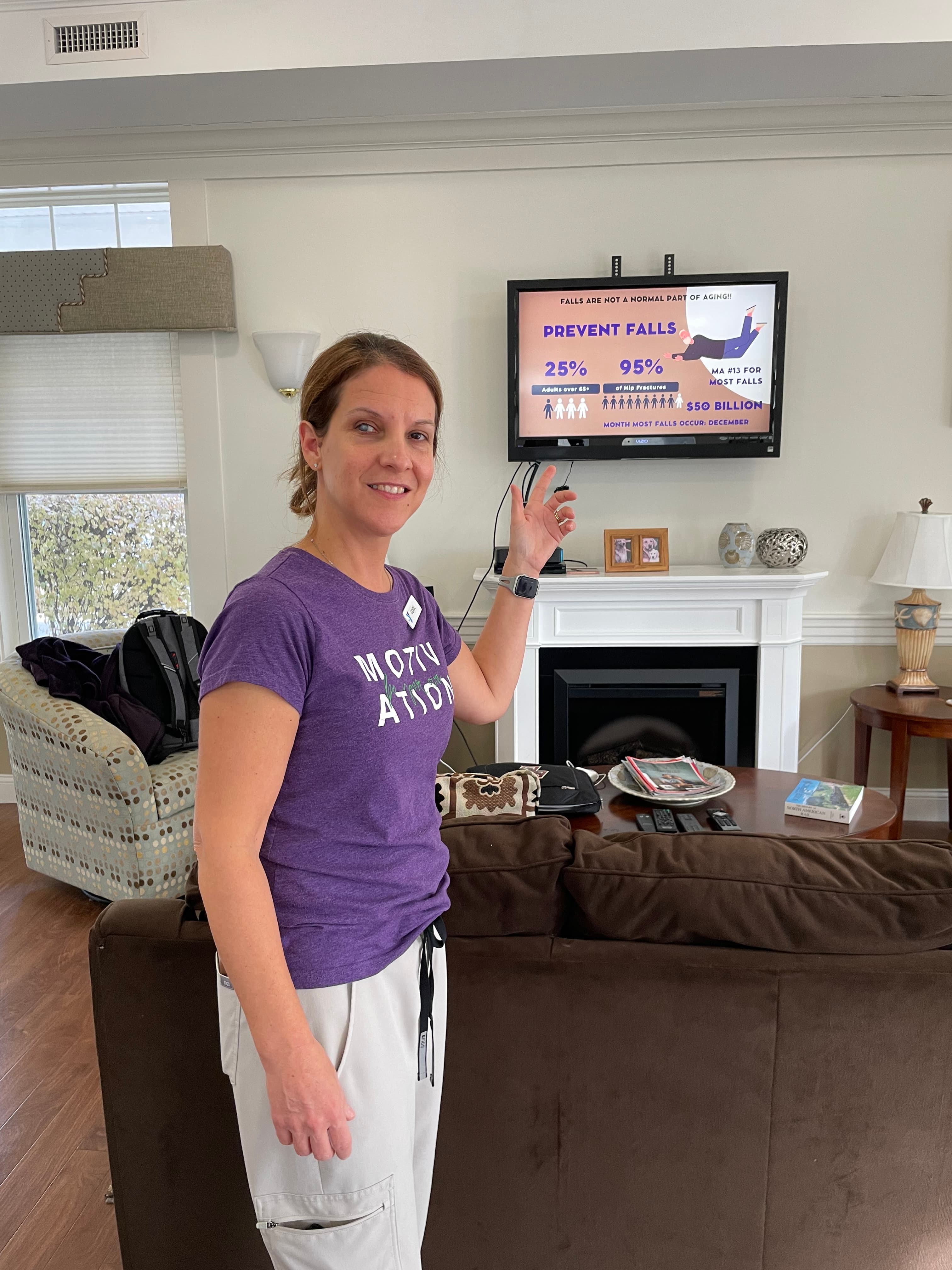 Kathy Clark presenting a fall prevention workshop with statistics slides in the background